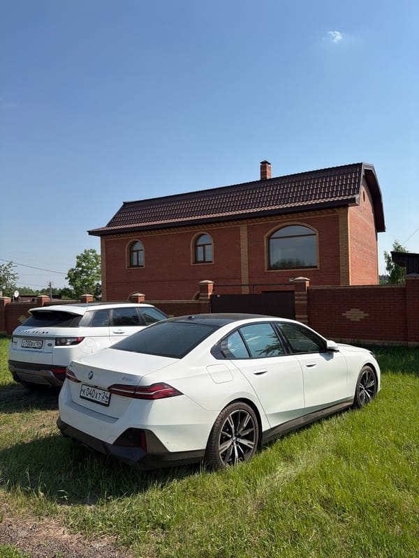 BMW sedan parked in residential Krasnoyarsk on sunny morning