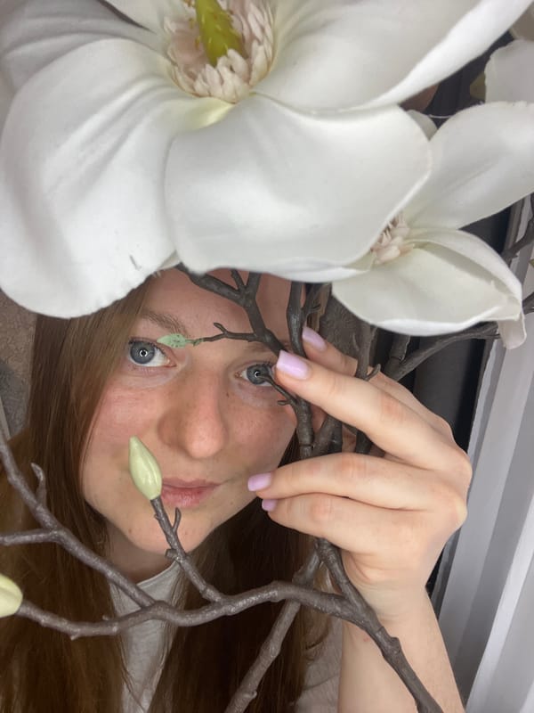 Woman photographed in flower-themed portrait session in Russian village