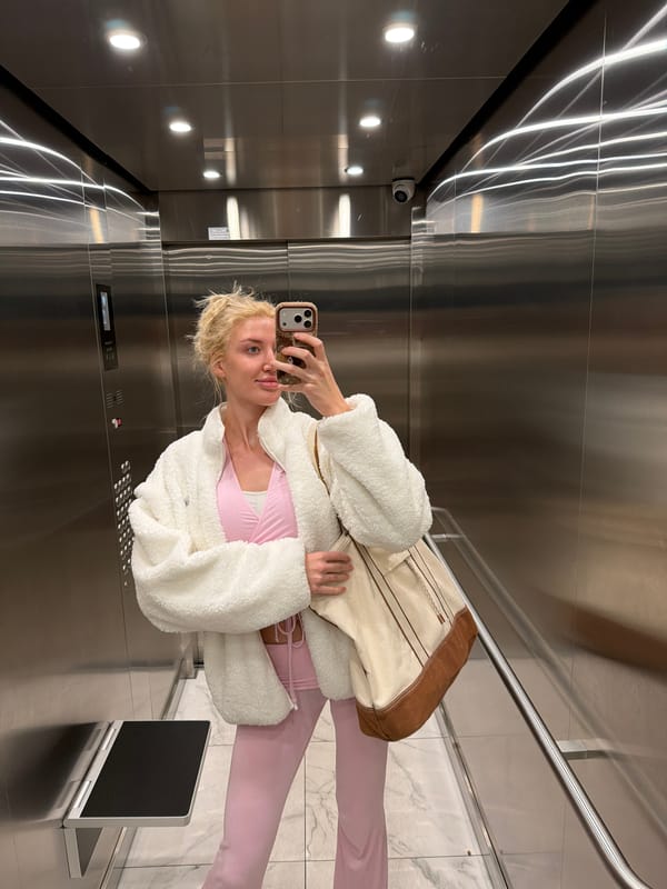 Woman in pink outfit documented during Belgrade elevator and meal