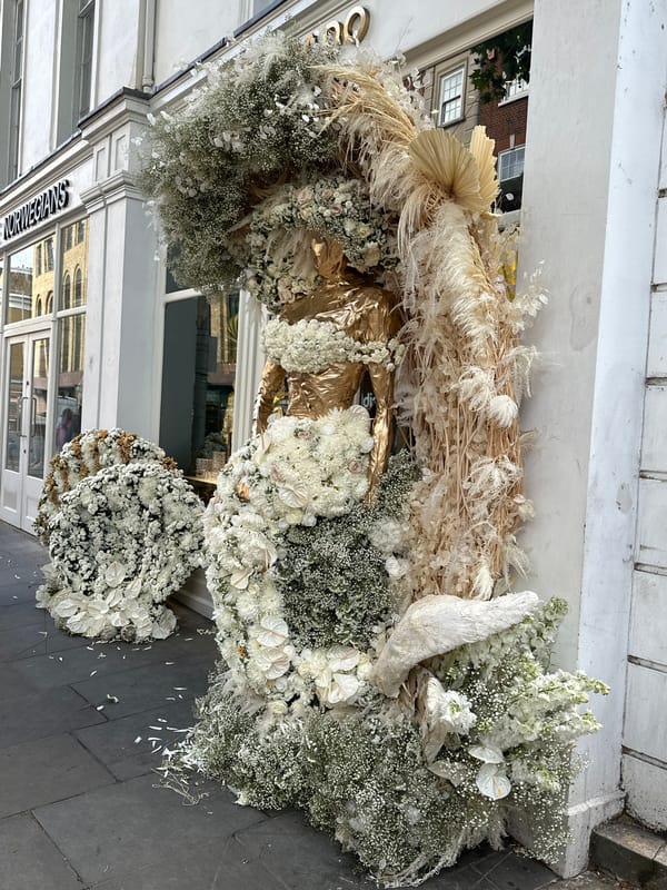 Elaborate floral displays appear outside London storefronts