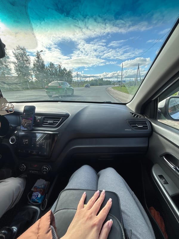 Car journey documented through Yaroslavl on sunny afternoon