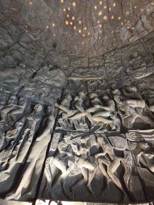 Tourist documents stone carvings at Santiago de Compostela memorial wall