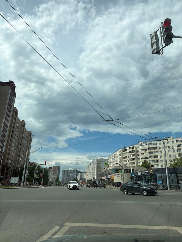 Street-level drive through Ufa under a dramatic summer sky