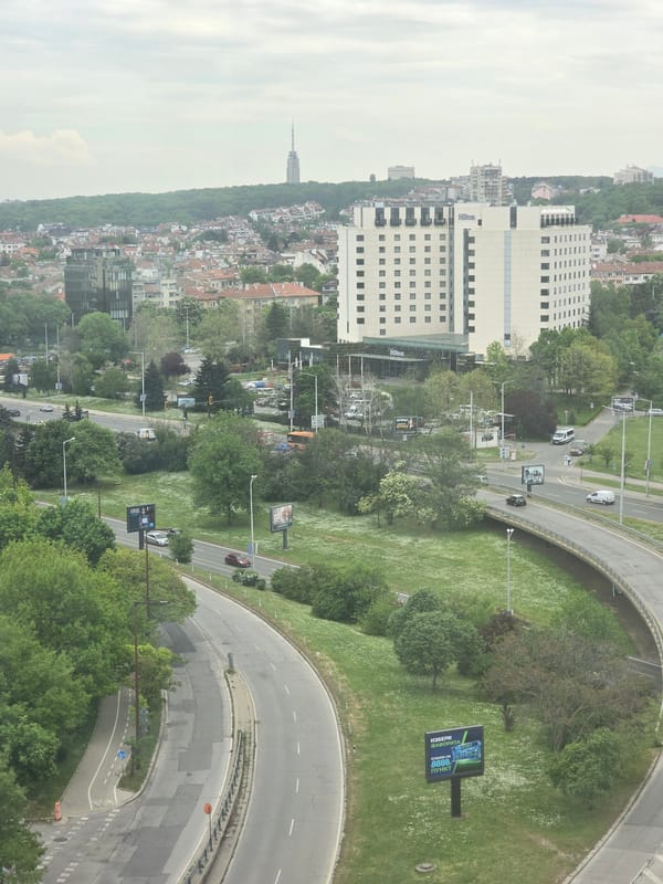 Aerial view captures Sofia cityscape with light highway traffic