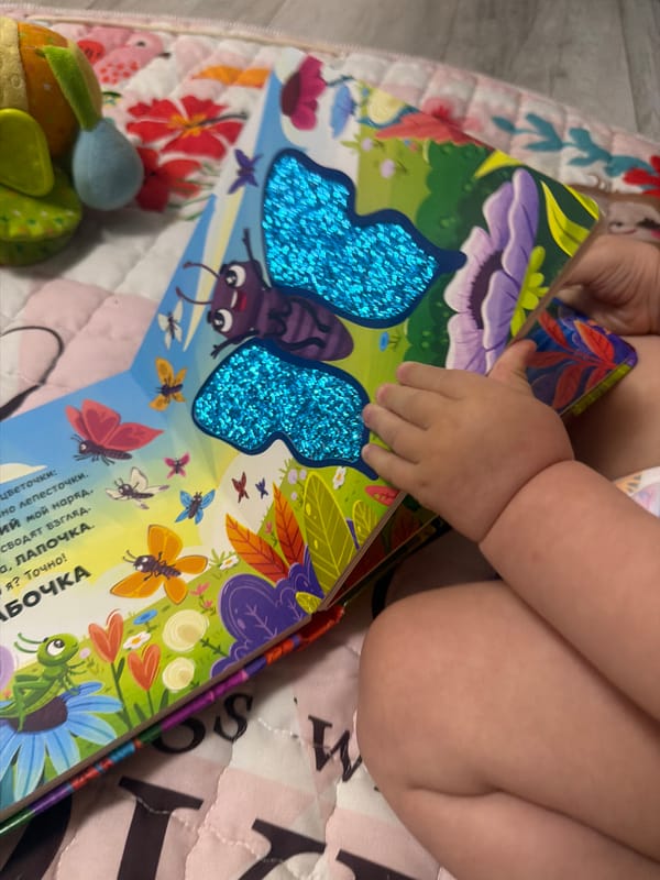 Toddler storytime with butterfly books and scattered toys