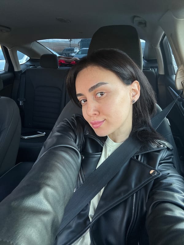 Woman takes selfies in car driver's seat in Tbilisi