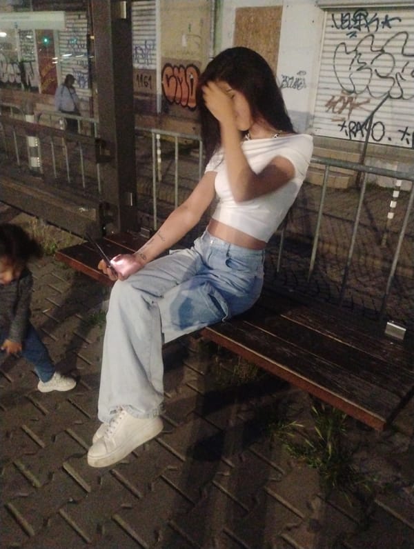 Woman and child observed on Sofia street bench evening