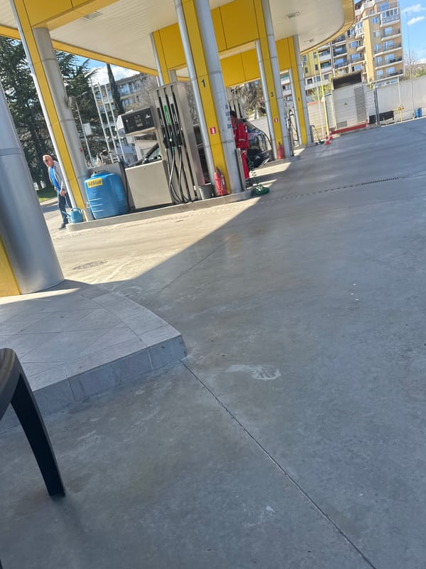 Urban gas station and building documented in city area