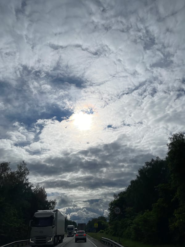 Cloudy skies observed during highway travel near Ol'khovka, Russia