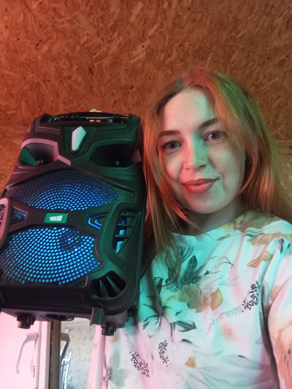 Person rests with speaker on floral surface