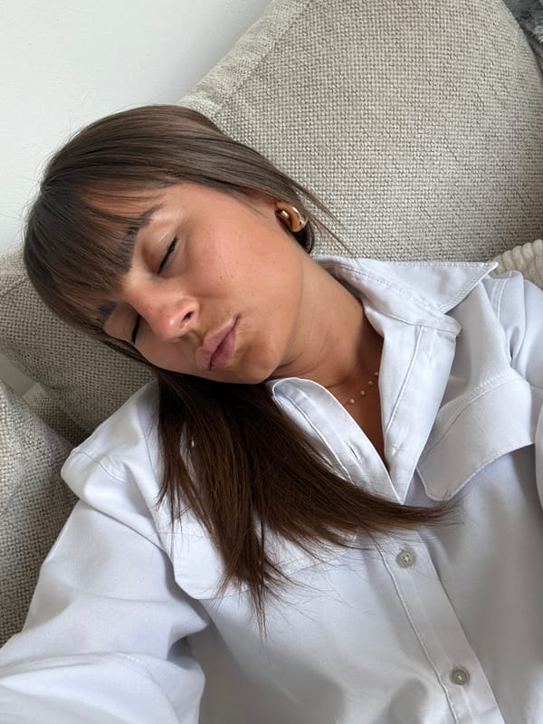 Woman rests on sofa in Cannes living space