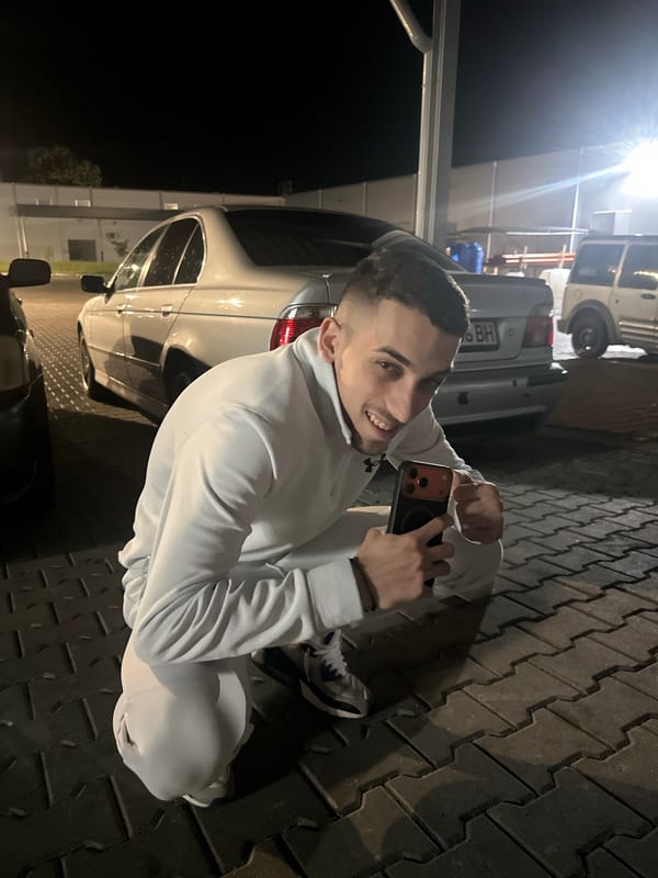 Young men gather for nighttime photo session in commercial area