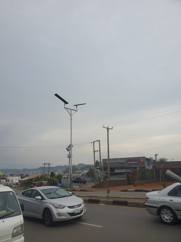 Evening traffic flows through Jos streets under cloudy skies