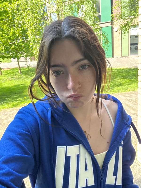 Woman takes selfies while moving through Hull city locations