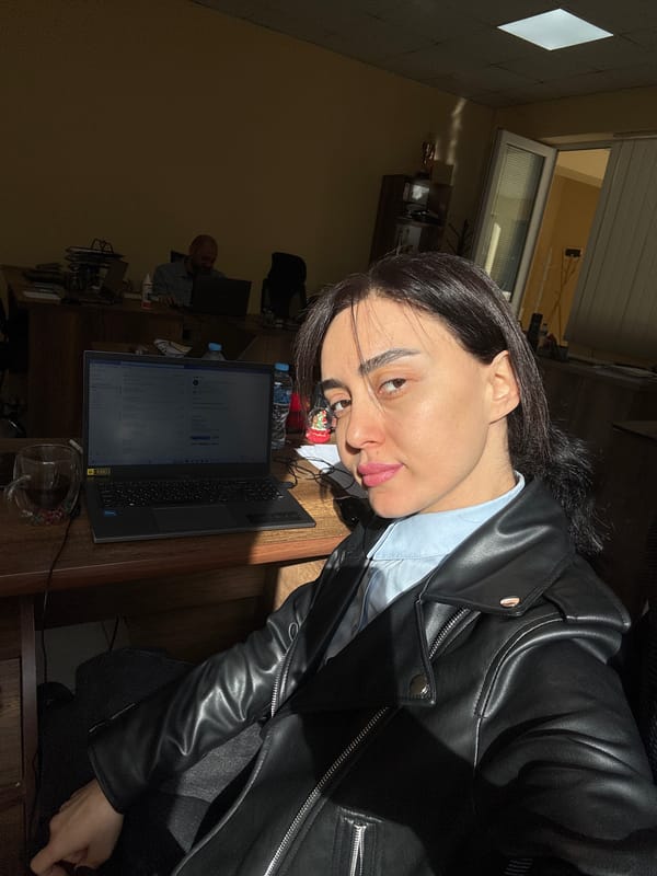 Woman works at office desk in early morning Tbilisi