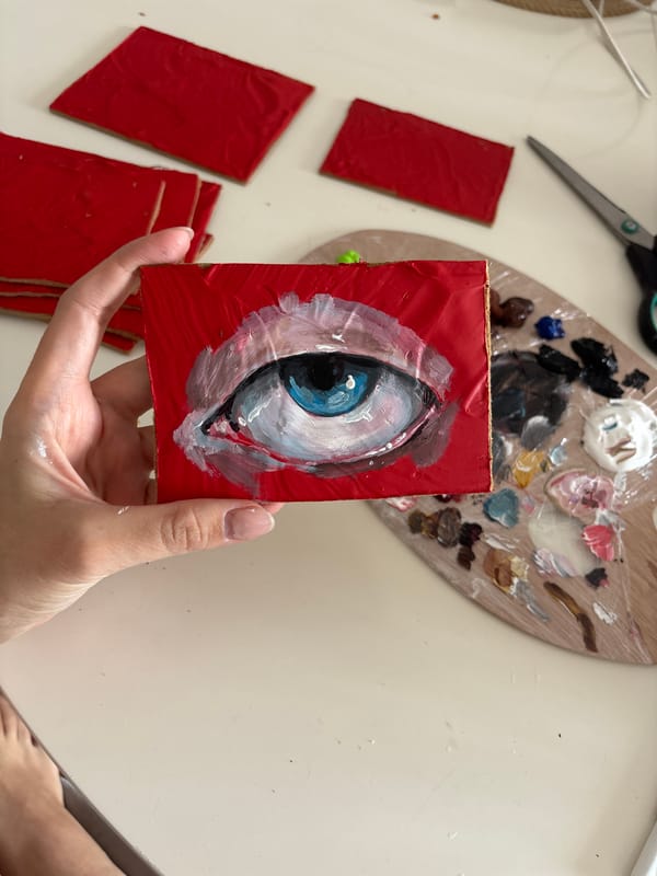 Person displays small eye painting in Krasnoyarsk