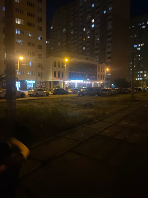 Nighttime street scene near a Kyiv residential block
