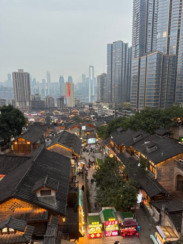 Evening crowds navigate illuminated streets in Chongqing's Yuzhong District