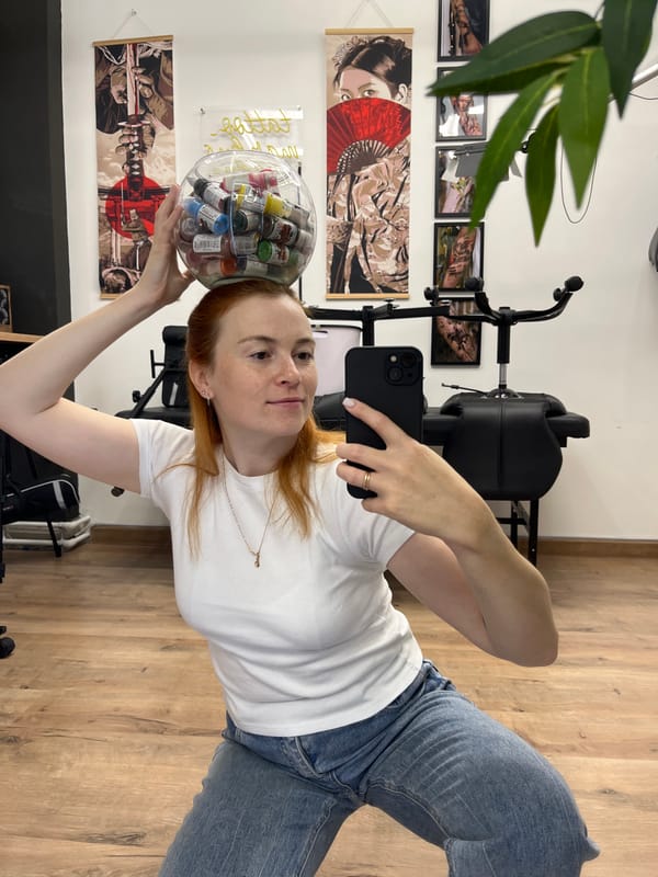 Mirror selfies in a Chaikovsky tattoo studio, ink bowl balanced on head