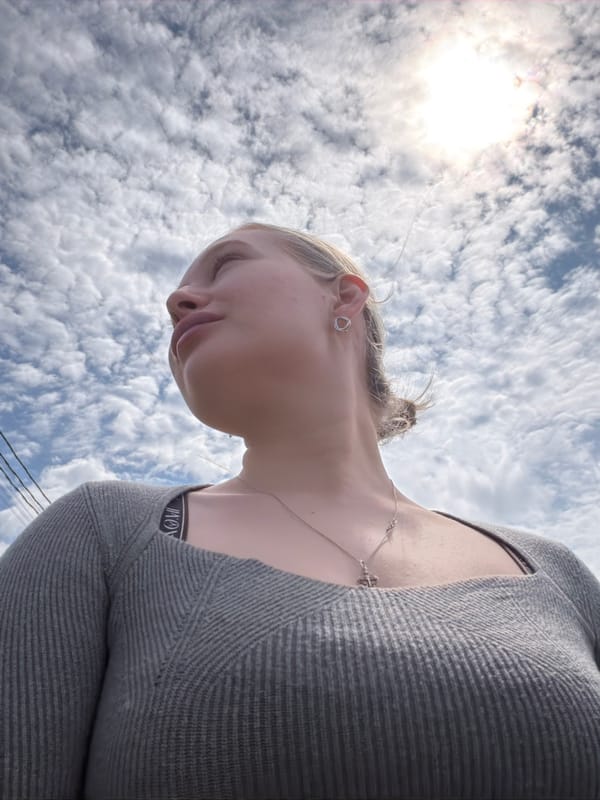 Woman takes selfies among spring flowers in Rossiyskiy
