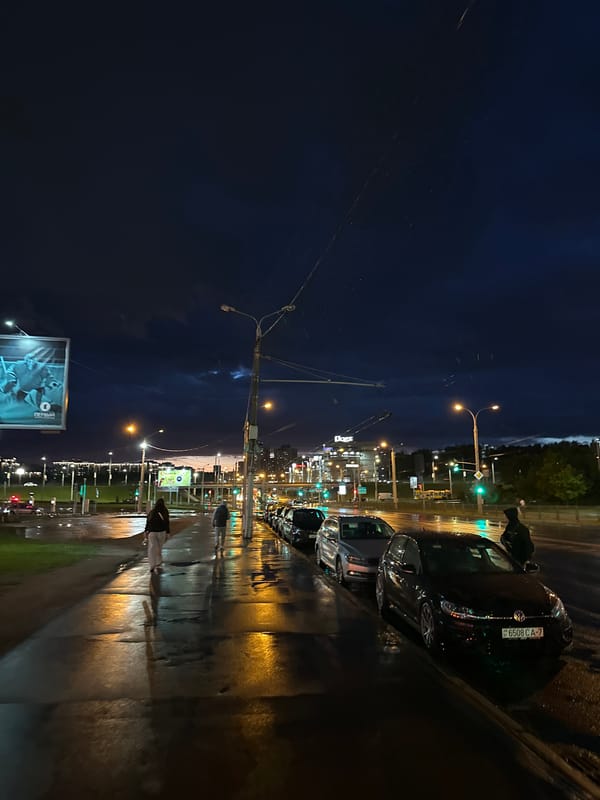 Rainy evening street life documented across central Minsk