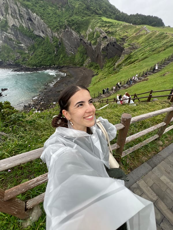 Woman takes selfies at Seogwipo coastal viewpoint early morning