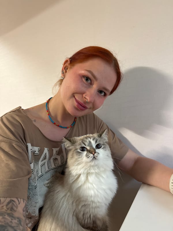 Woman photographs herself with cat, orchids in Rostov-on-Don