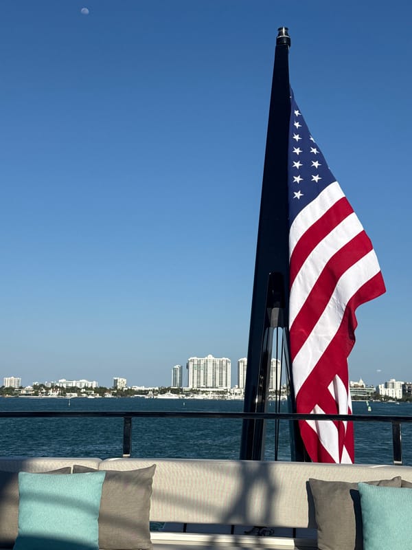 American flag waves from boat near Miami Beach skyline