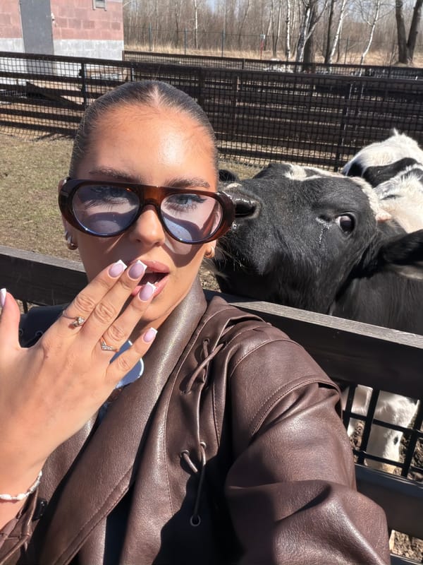 Woman poses with cow in sunny selfie in Berezovka
