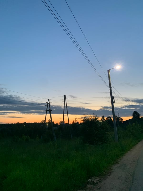 Dusk settles over a rural road in Ganino, Russia