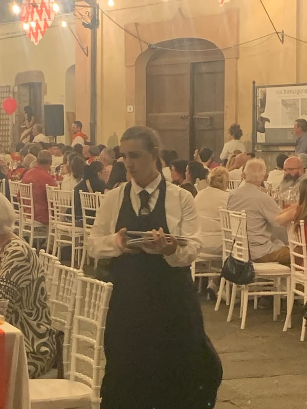 Summer evening event in San Quirico d'Orcia's cobblestone streets