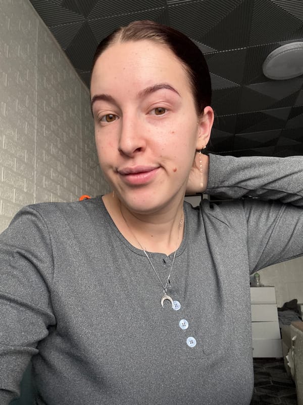 Woman photographed indoors in Donetsk wearing crescent moon necklace