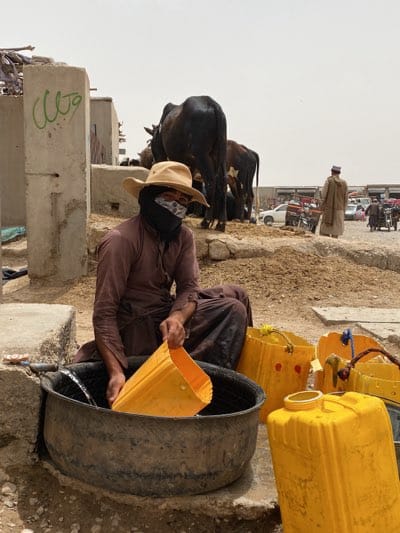 Morning water collection and livestock activities in Jabadar, Afghanistan