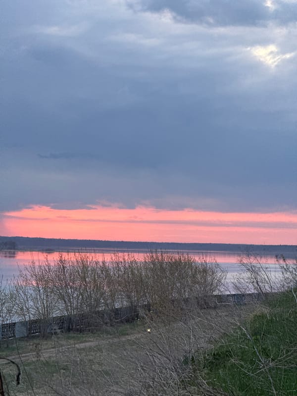 Sunset observed over lake in Izhevsk with pedestrians present