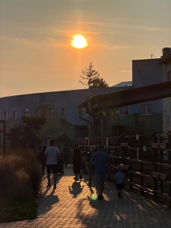 Golden hour on a Perm walkway, sun low and people out