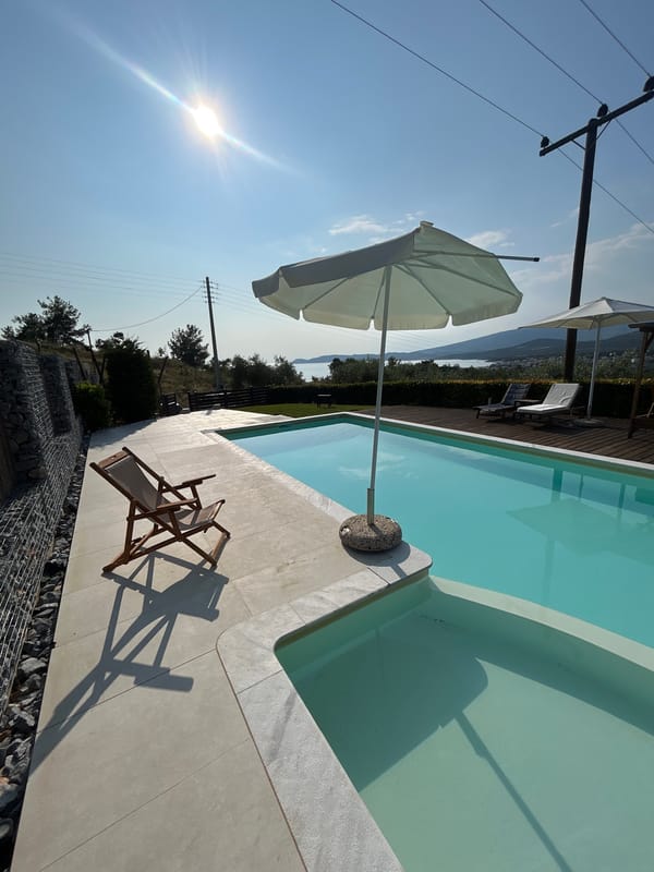Sunny afternoon at a hillside pool with countryside views