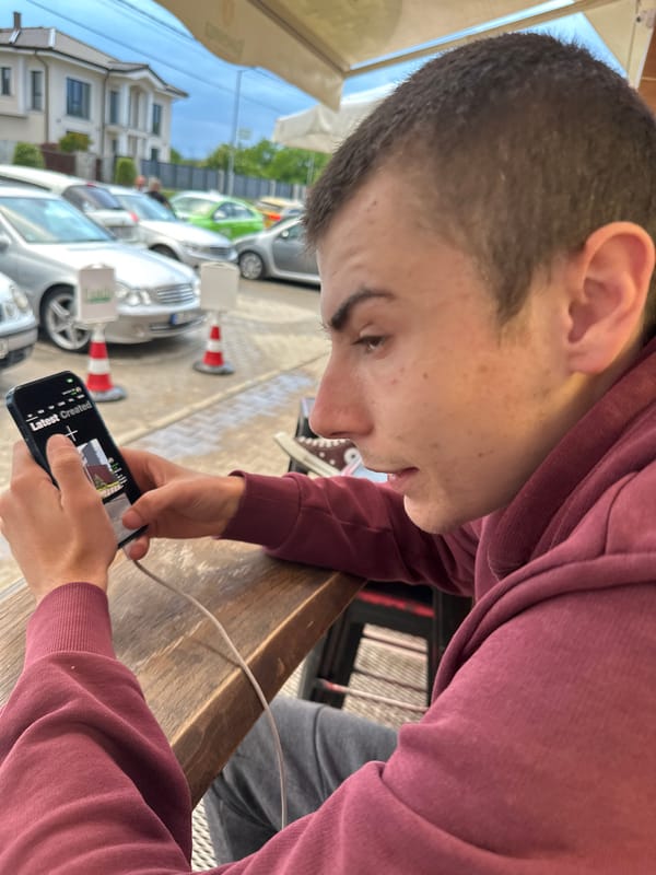 Young man uses phone at outdoor café in Plovdiv