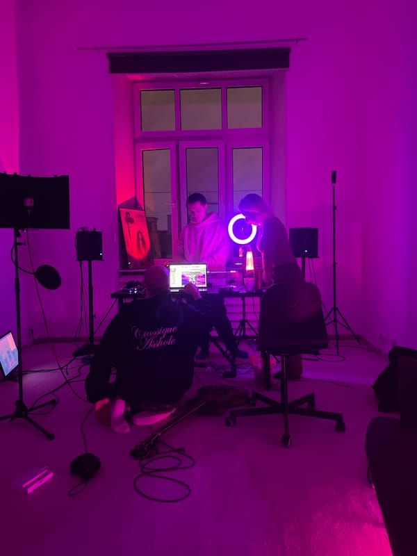 Two people gather in colorfully lit indoor space