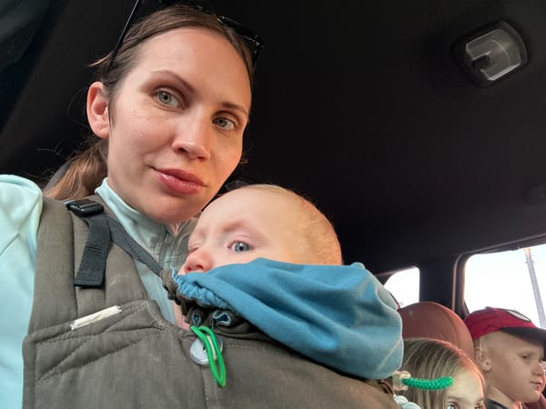 Woman takes selfie with child in carrier in Fethiye