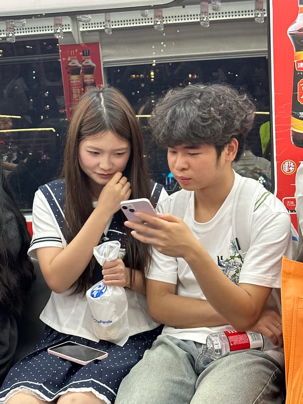 Young couple uses phones on public transit in Chongqing