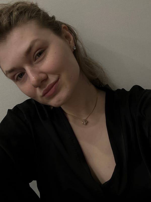 Woman in black garment, gold necklace observed in Kazan