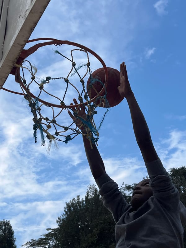 Outdoor basketball dunks at a court in Kamakwa, Kenya