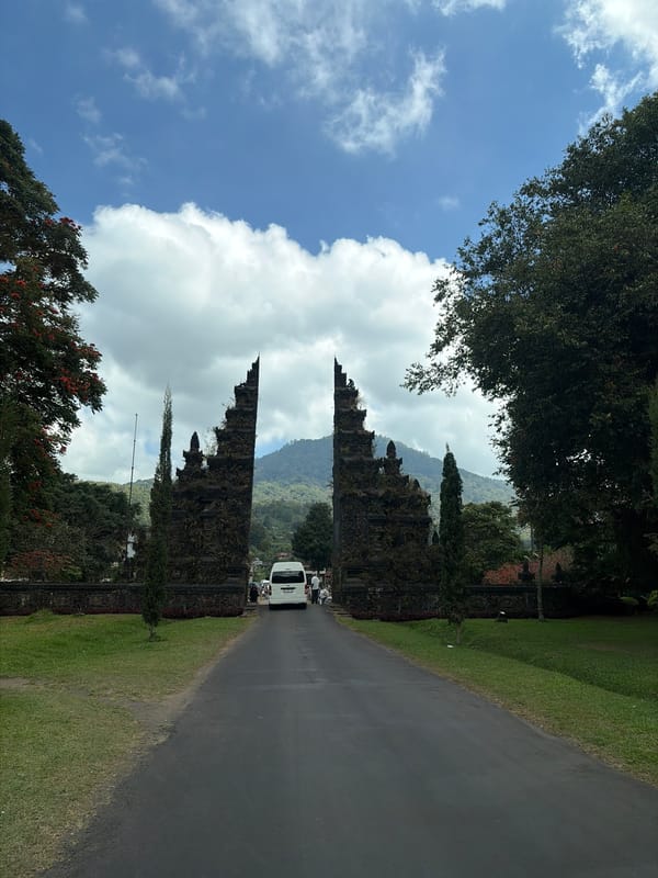 Bali's iconic Handara Gate framed by mountains and green fields