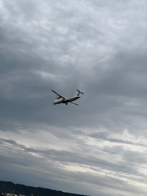 Longtail boats, oyster-crusted rocks, and a turboprop over Ko Samui