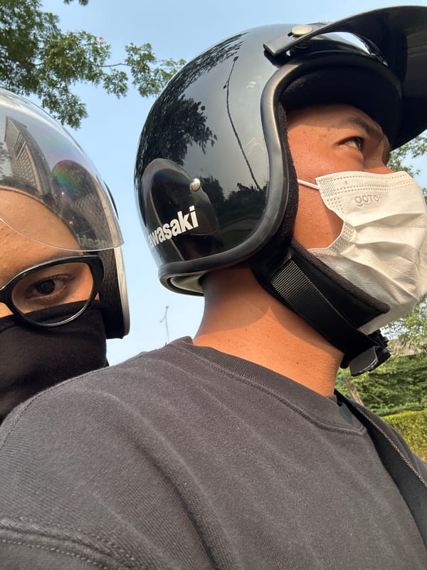 Helmeted motorcycle riders moving through South Tangerang streets
