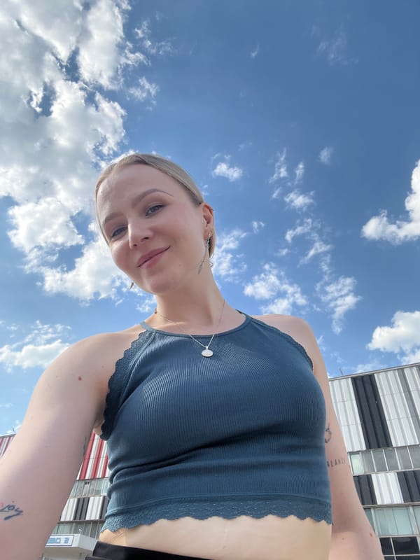 Woman takes selfies outside commercial building in Khimki