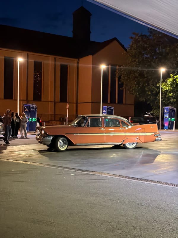 Classic pink Plymouth Fury parked on wet streets in Luxembourg