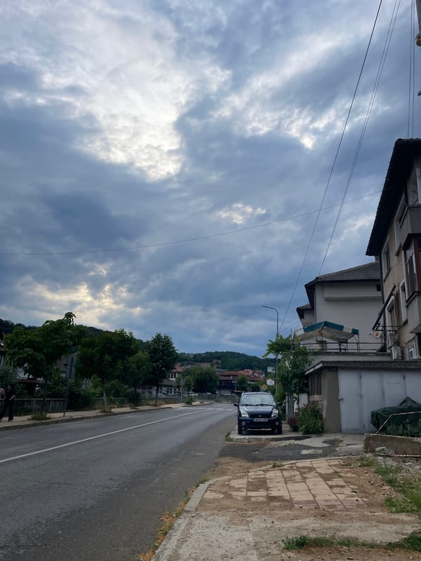 Street-level views of Zlatograd under a cloudy July sky