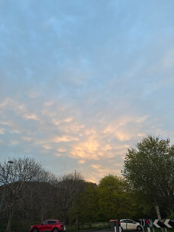 Evening traffic flows under sunset skies along highway