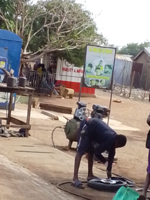 Man performs tire repair work in Tamale, Ghana